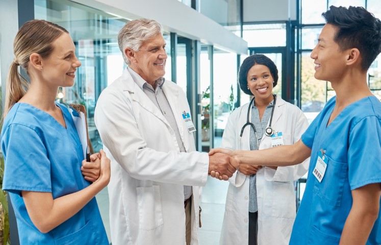 Hospital director congratulating healthcare employee